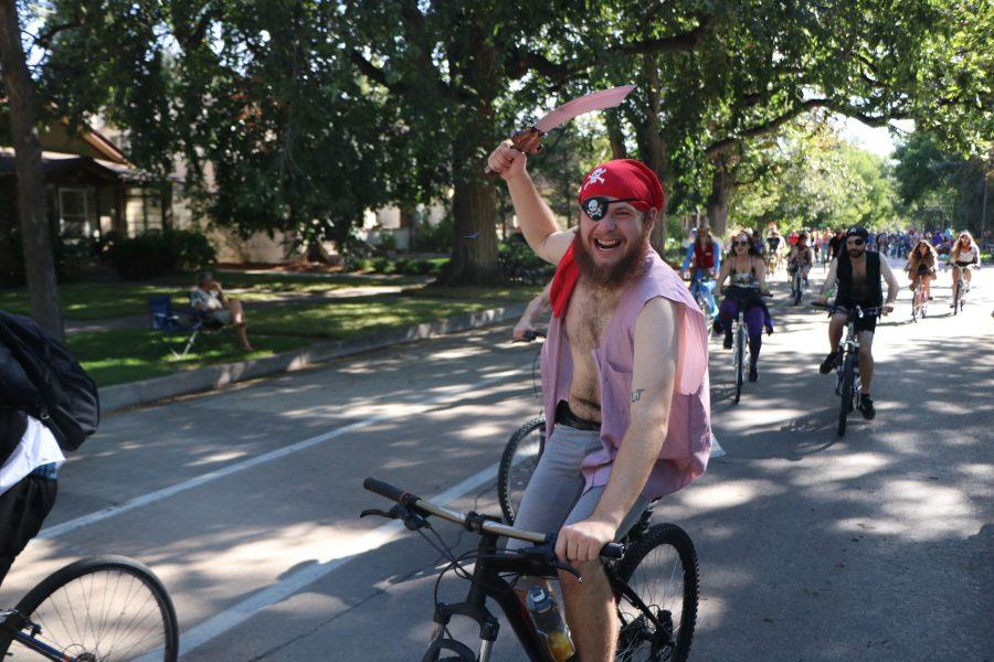 A pirate gives his best impression while heading down the Tour De Fat parade. (Devin Cornelius | Collegian)