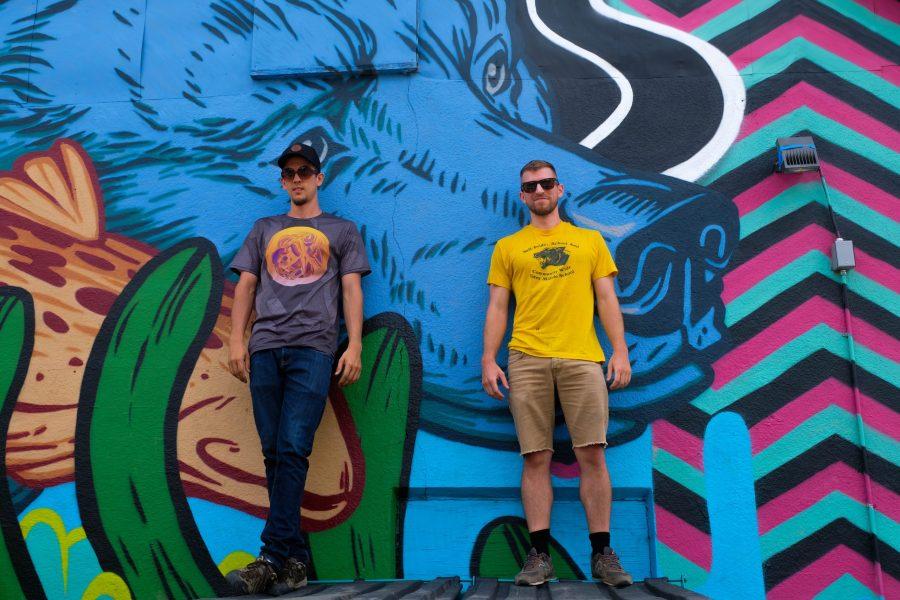 Abram Aleo and Travis Gillan pose in front of their mural. This was the Denver-based pairs first collaboration project. (Laurel Bolz | Collegian)