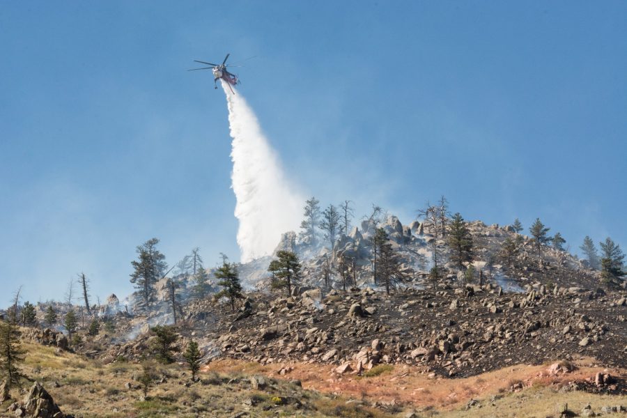 A helicopter drops water over the Seaman Fire in Poudre Canyon. The Seaman fire has grown to over 130 acres as of Sept. 12. (Colin Shepherd | Collegian)