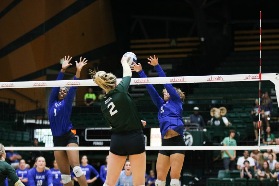 Sophmore Ellie Gubser (#2) spikes the ball down toward the ISU defense (Devin Cornelius | Collegian)