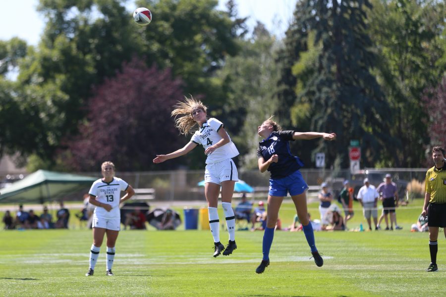 Sophomore Forward Taylor Steinke (4) and SMU Defender Brooke Golik (18) jump to head the ball out of the air during the second half of play on September 16, 2018 at the Rams Soccer Complex. (Elliott Jerge | Collegian)