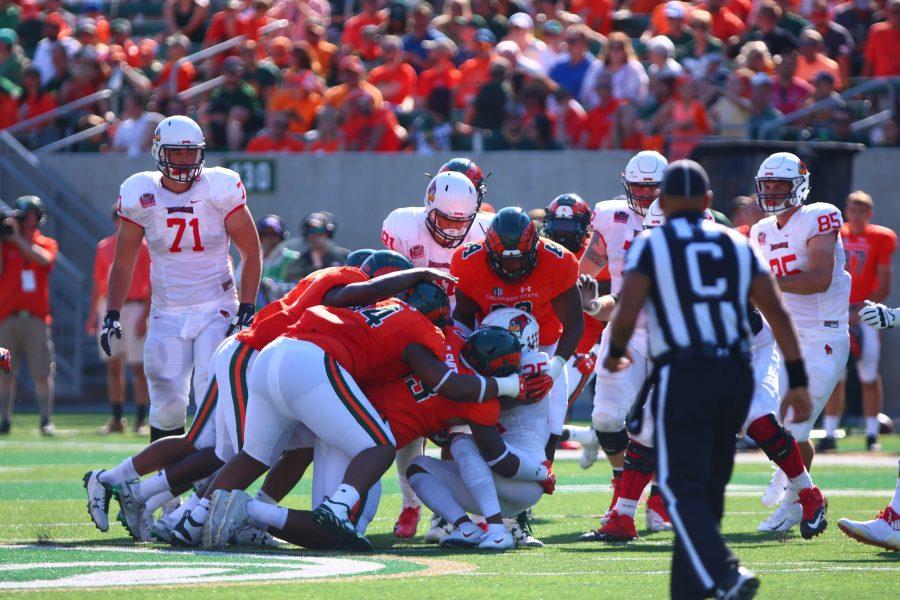 The Rams defensive line tackle an Illinois State offensive man during the fourth quarter of the  game on Sept. 22nd. The Rams lost 19-35. (Matt Begeman | Collegian)