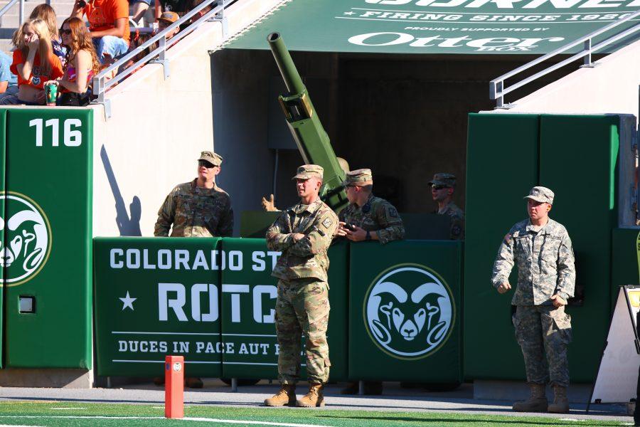 Photo of CSU Army ROTC member standing on the Canvas Stadium field below the stands.