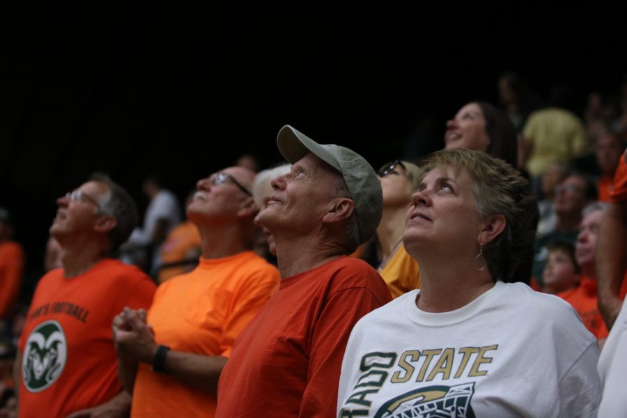 Members of the croud look up at the score. (Devin Cornelius | Collegian)