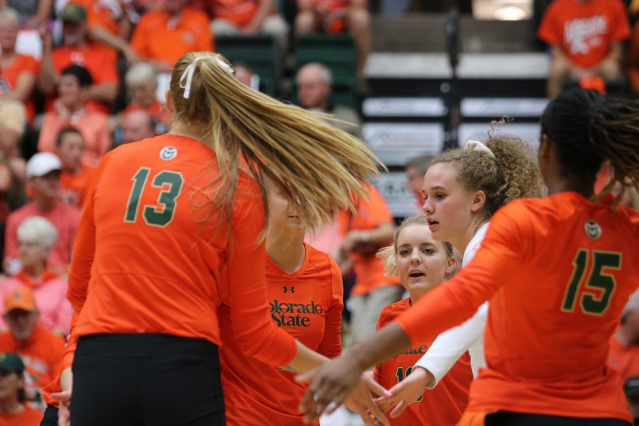 The team gives each other pats after a good volley. (Devin Cornelius | Collegian)