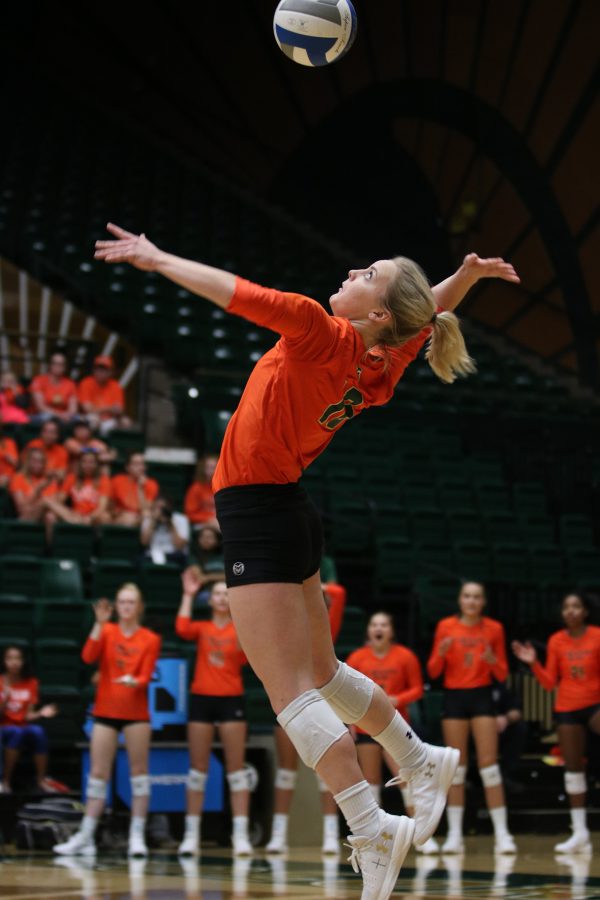 Maddi Foutz jumps up to server the ball at the start of the game. (Devin Cornelius | Collegian)