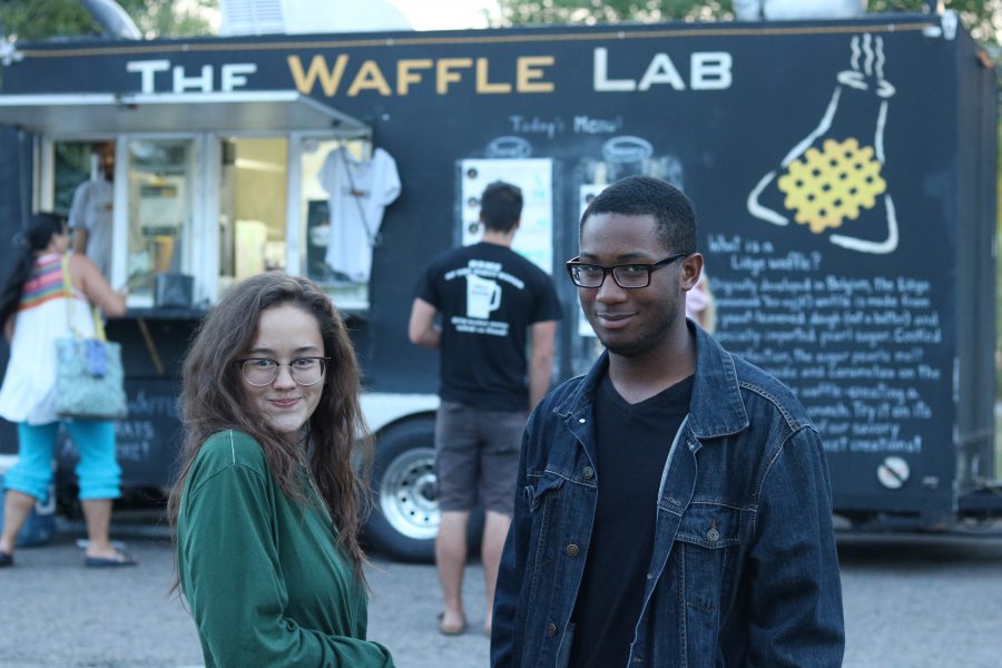 Maria Flores and Tyeler Fields atand in front of The Waffle Lab food truck during a food truck rally. (Devin Cornelius | Collegian)