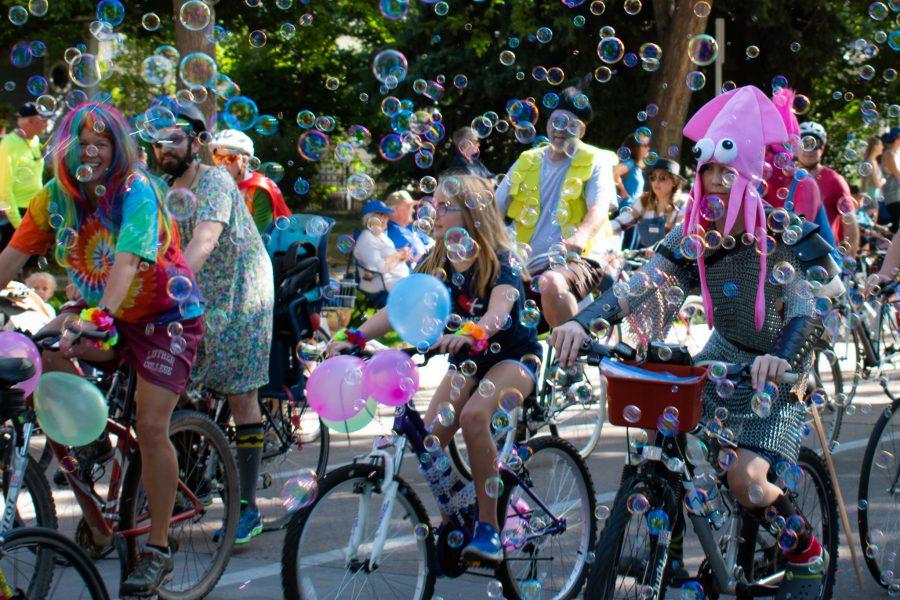Participants in the Tour de Fat ride their bikes through bubbles in the bike parade on Sept. 1, 2018, in Fort Collins, Colo. (Sara Graydon I Collegian)