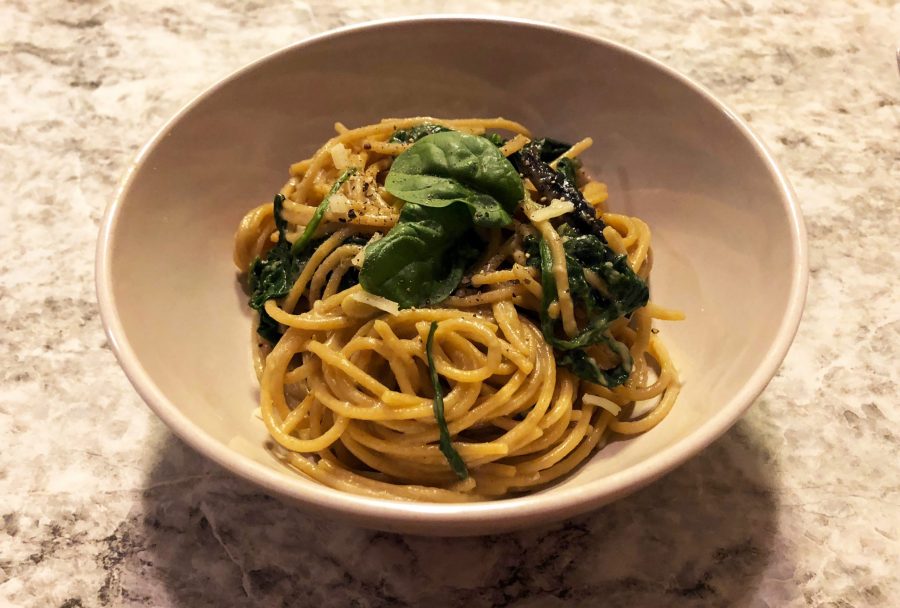 A bowl of fresh carbonara, topped with spinach, onions, and mushrooms. (Audrey Weiss | Collegian)