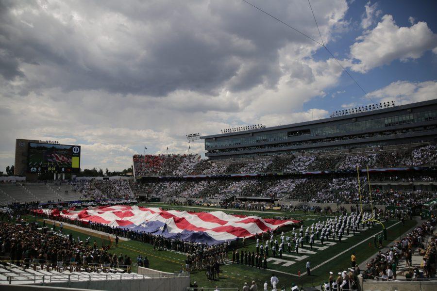 A football-field sized American flag is unfurled before the start of Colorado State Universitys first football game of the season against Oregon State, on Saturday, August 26th. Forrest Czarnecki | The Collegian