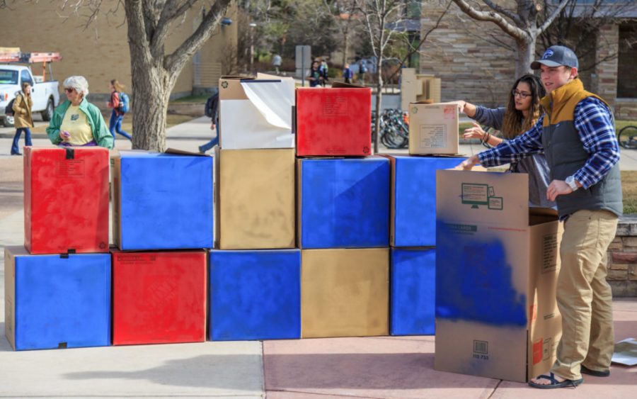 College Republicans at CSU members erect their Free Speech Wall for people to write on during the To Immigrants With Love event on the plaza hosted by Dreamers United. February 8, 2017. (Davis Bonner | Collegian)