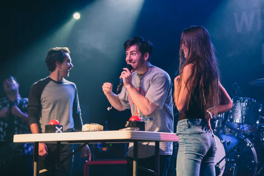 Two audience members prepare to play a Hoodie Allen themed variant of Family Feud with questions based on Hoodies career during his performance at the Aggie Theater on Friday. (Davis Bonner | Collegian)