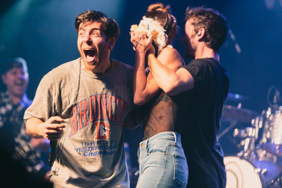 An audience member takes a cake to the face after losing a Hoodie Allen-themed variant of Family Feud during his performance at the Aggie Theater on Friday. (Davis Bonner | Collegian)