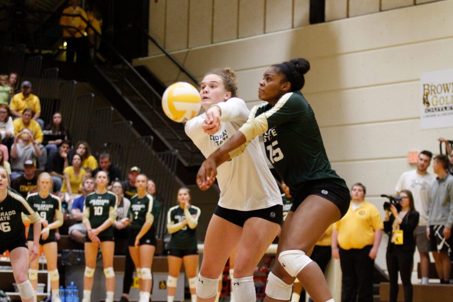 Olivia Nicholson and Breana Runnels both attempt to dig a ball during the game against Wyoming. (Ashley Potts | Collegian)