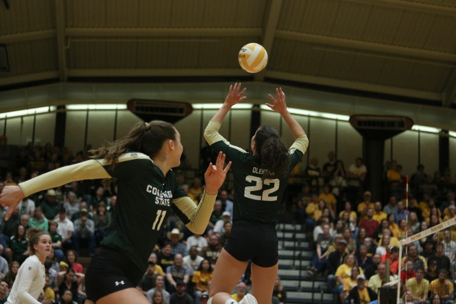 Katie Oleksak jump sets Paulina Houggard-Jensen  during their game against Wyoming (Devin Cornelius | Collegain)