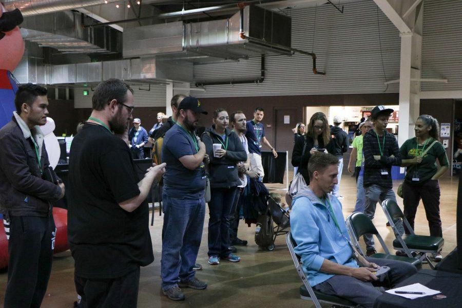 People watch as a man plays a racing game on the N64 (Devin Cornelius | Cornelius)