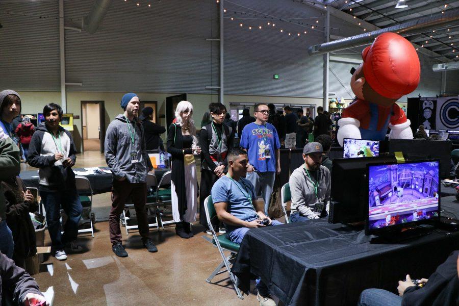People watch as contenders battle in the preliminary rounds of the super smash bros tournament at VinCon (Devin Cornelius | Collegian)