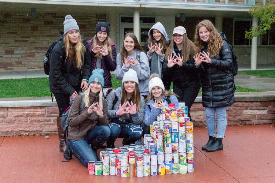 Members of the Zeta Tau Alpha sorority post next to their cans during the CANstruction on the CSU plaza. (AJ Frankson | Collegian)