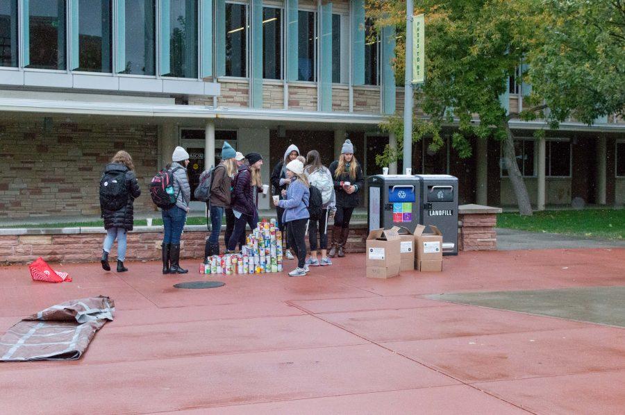Members of the Zeta Tau Alpha sorority stand by their cans despite the near-freezing temperatures during the CANstruction on the CSU plaza. (AJ Frankson | Collegian)