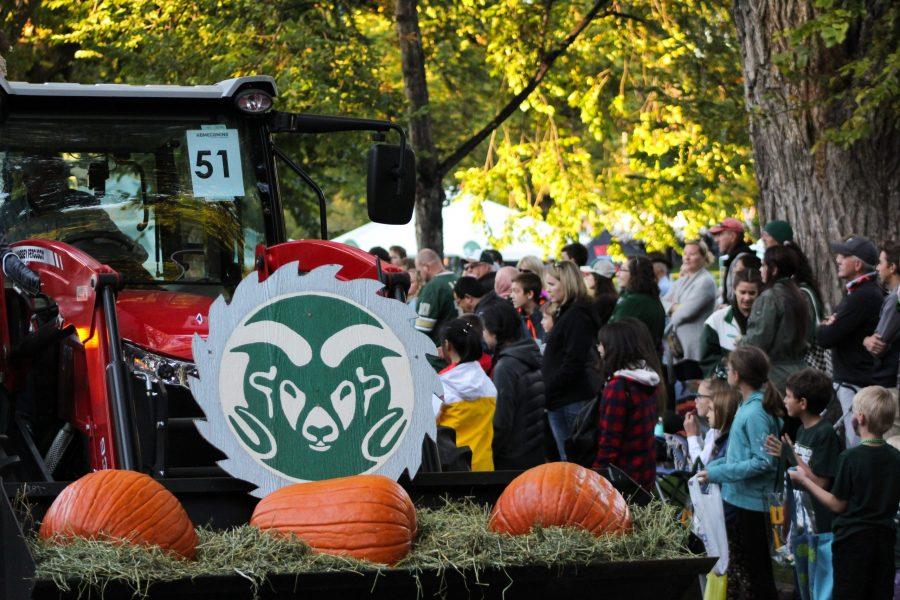CSU Traditions float carries pumpkins as it passes through the crowd during the homecoming parade Friday, Oct. 12