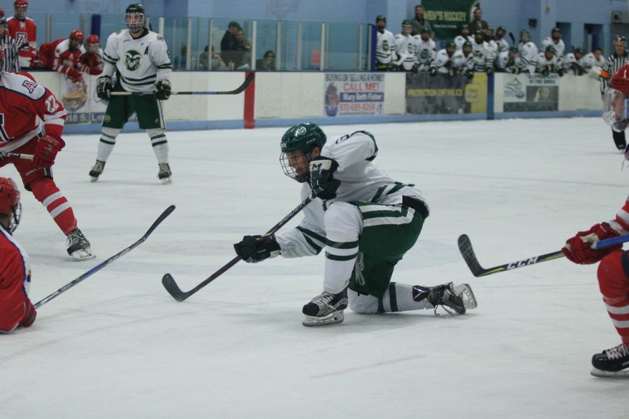 Jonathon Johnson (3) shoots the puck into the goal for CSU's first point. (Devin Cornelius | Collegian)