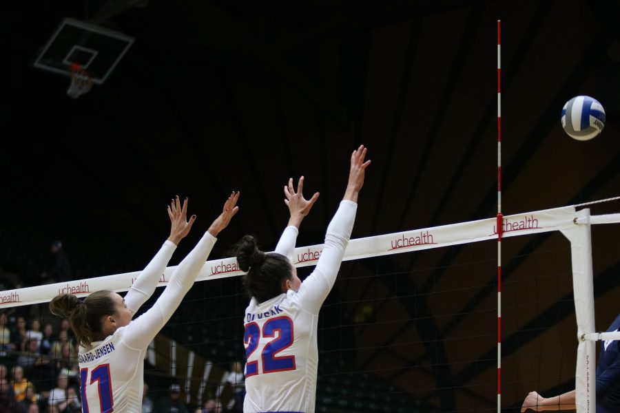 Katie Oleksak(22) and  Paulina Hougaard-Jensen(11) leap up to stop the ball from landing on their side.(Devin Cornelius | Collegian)