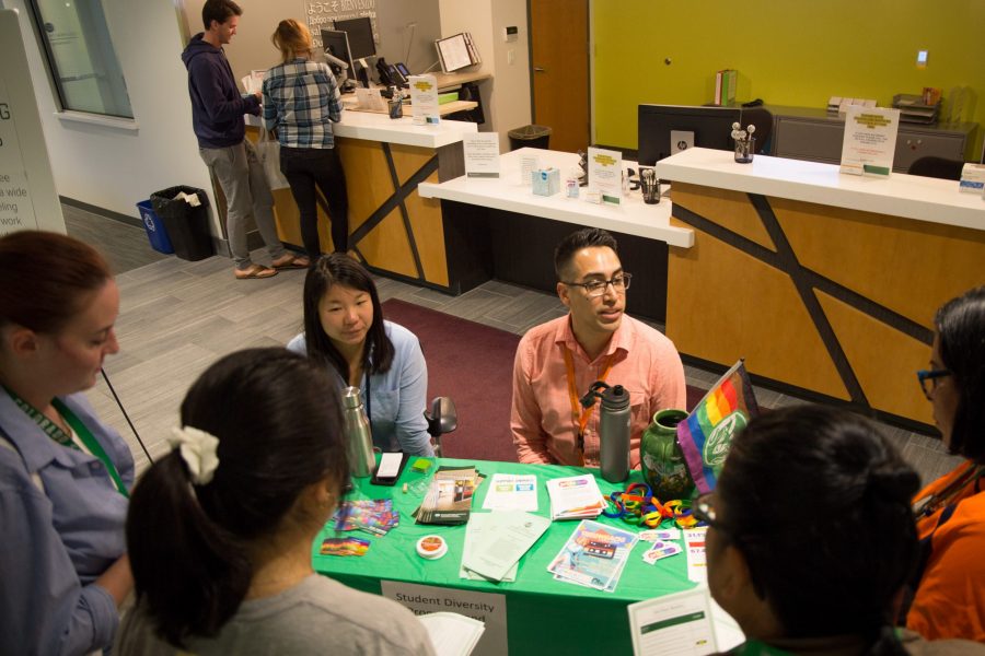Ellie Shuo Jin anf Adam-Jon Aparicio, work the Student Diversity Program table at the CSU Health Care. (Anna Baize | Collegian)
