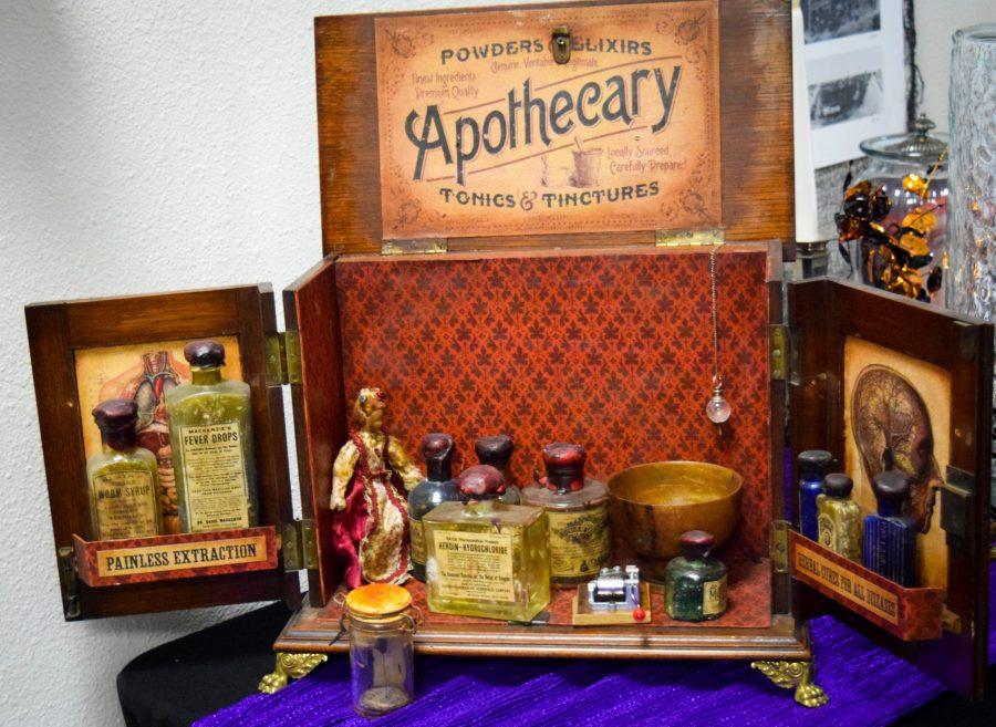 A traditional apothecary kit decorates a table of snacks outside Paul Noffsingers magic and illusion show in Fort Collins on Friday October 19, 2018. Paul is a renowned magician and story teller. (Alyse Oxenford | Collegian)