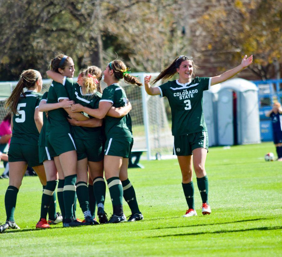 Makenzi Taylor welcomes a fellow team member to the celebration after the game-winning goal scored by Caeley Lordemann on October 21, 2018. (Alyse Oxenford | Collegian)