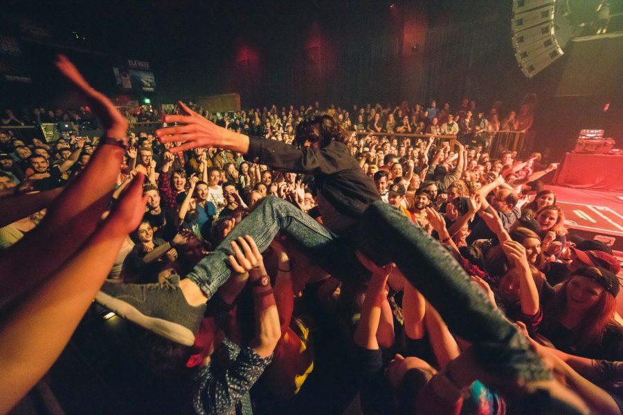 During his performance at the Fox Theater in Boulder, Watsky surfs the crowd. (Davis Bonner | Collegian)