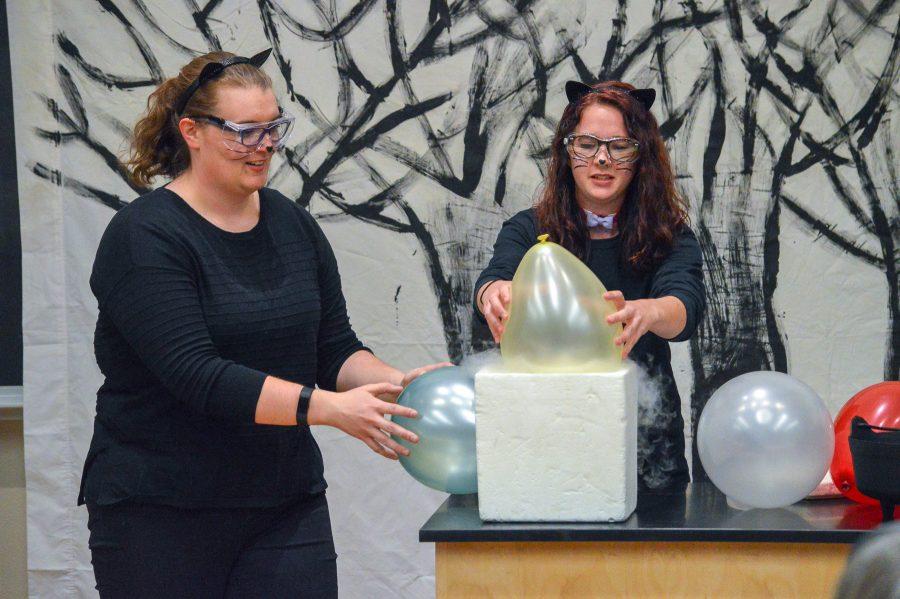 Chemistry Graduate Students, Maggi Braash-Turi and Lacey Beck, perform an experiment using liquid nitrogen during one of the shows at the Chemistry Clubs Halloween Spooktacular Event. (Mackenzie Pinn | Collegian)