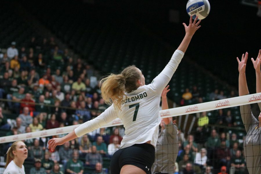 Sasha Colombo (7) taps the ball over the net towards the Wyoming defense. (Devin Cornelius | Collegian)
