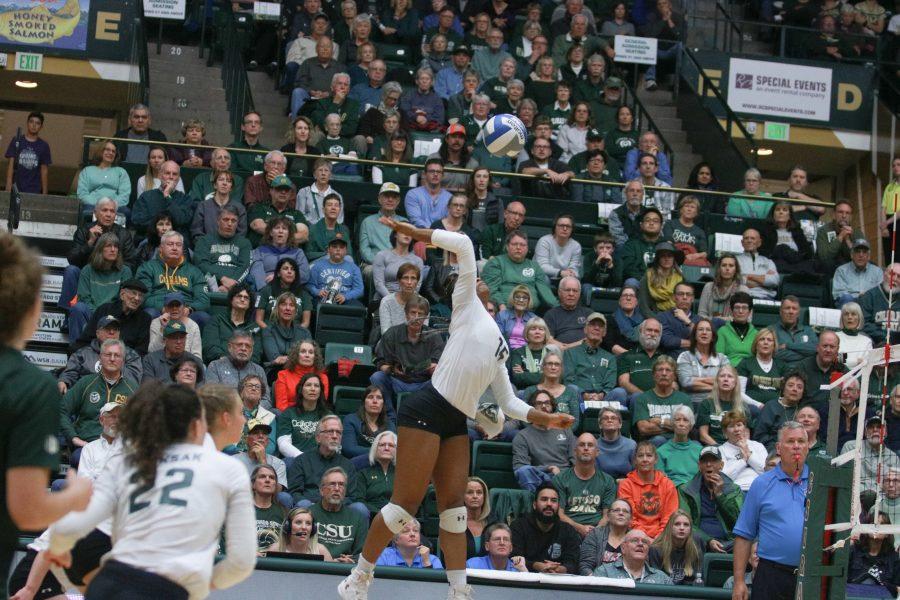 Breana Runnels (15) spikes the ball down onto the Wyoming side. (Devin Cornelius | Collegian)