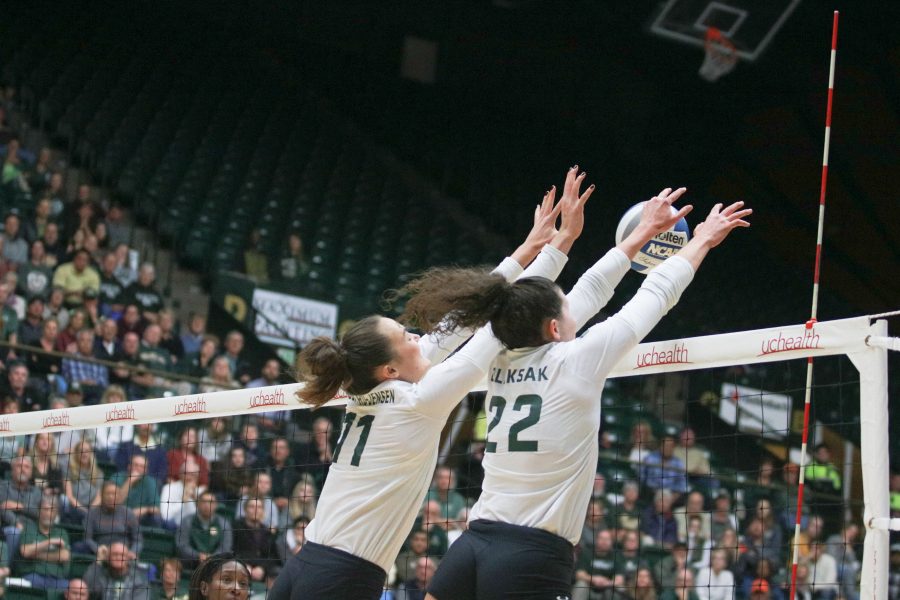 Paulina Hougaard-Jensen (11)  and Katie Oleksak (22)  block a Wyoming spike. (Devin Cornelius | Collegian)