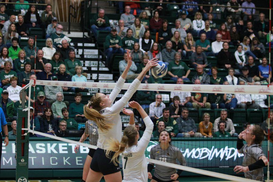 Kristie Hillyer (13) bats the ball down and scores a CSU point. (Devin Cornelius | Collegian)