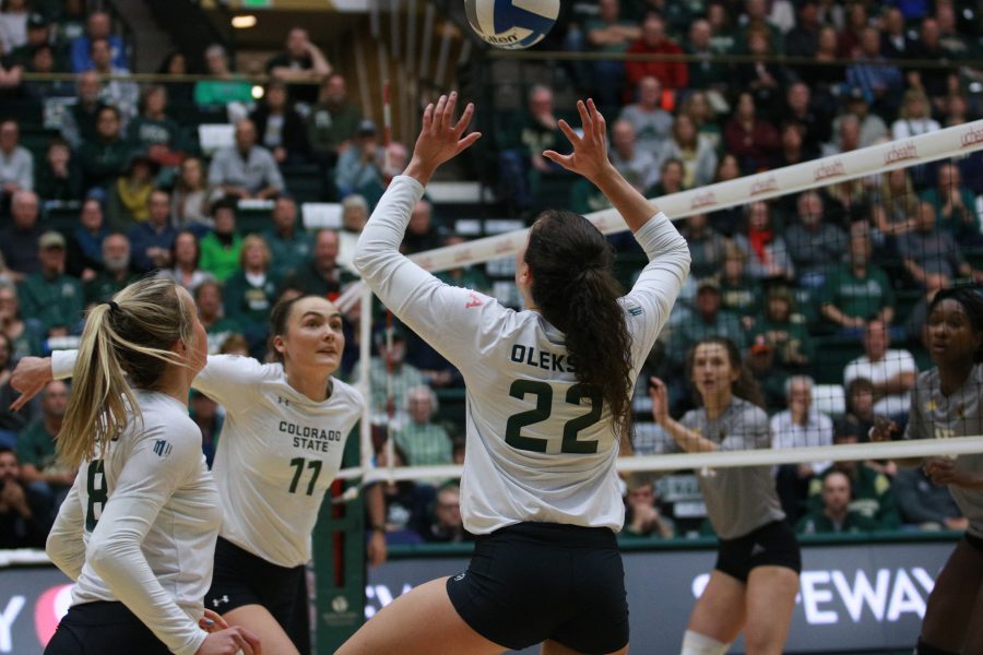 Katie Oleksak (22) sets the ball for Paulina Hougaard-jensen during CSU's game against Wyoming. (Devin Cornelius | Collegian)