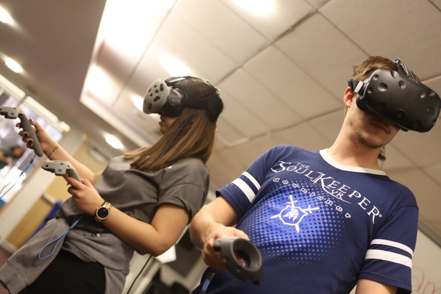Members from Team Awesome test their virtual reality headset during the Ram Reality 48-hour Create-A-Thon in the Morgan Library. Team Awesome developed a virtual reality multi-user template using development tools by Unreal Engine 4. (Brooke Buchan | Collegain) 