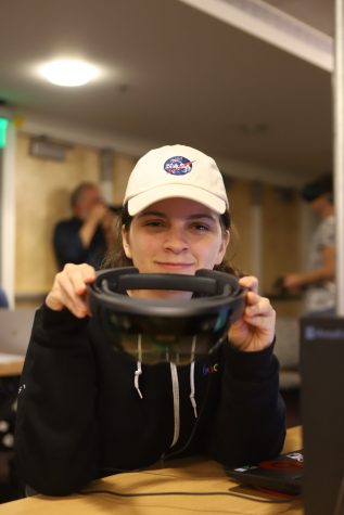 girl holds up headset