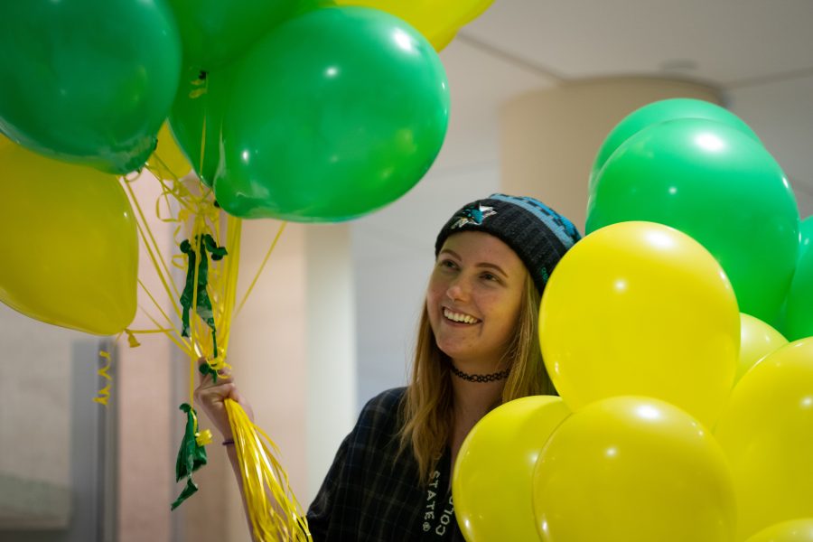 Madison Gould, an Art major at CSU, decorates the Lory Student Center with green and yellow balloons for homecoming weekend. She is part of Colab: the Lory Student Center Marketing  collaboration and enjoys getting to be a part of all the various projects that take place there. Gould says, We decorated in order to make the LSC a more festive and inviting place for visiting families.  (Brooke Buchan | Collegian) 