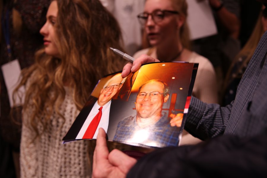 A man waits to have Dennis Prager autograph a picture following Prager's speech on campus on Oct. 29, 2018. (Forrest Czarnecki | Collegian)