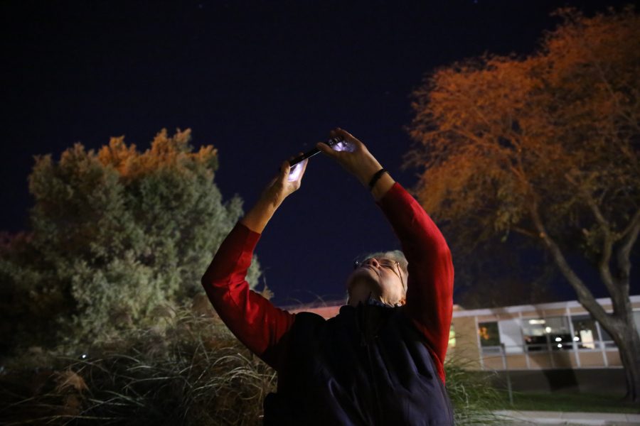 Linda Siegfried uses an app on her smartphone to outline specific stars and constellations during an open house event at the Madison-McDonald Observatory on campus on Oct. 19, 2018. (Forrest Czarnecki | Collegian)