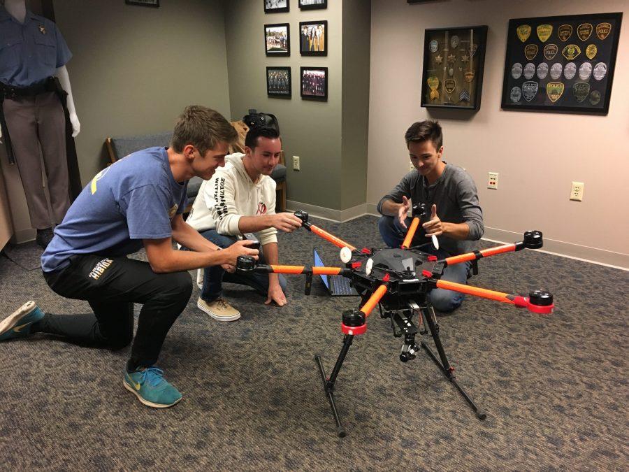 Engineering Students Galen Burr, David Miller, and Karl Mallinger work 
on a CSU Drone Center aircraft for a research project. (Photo courtesy of the CSU Drone Center)
