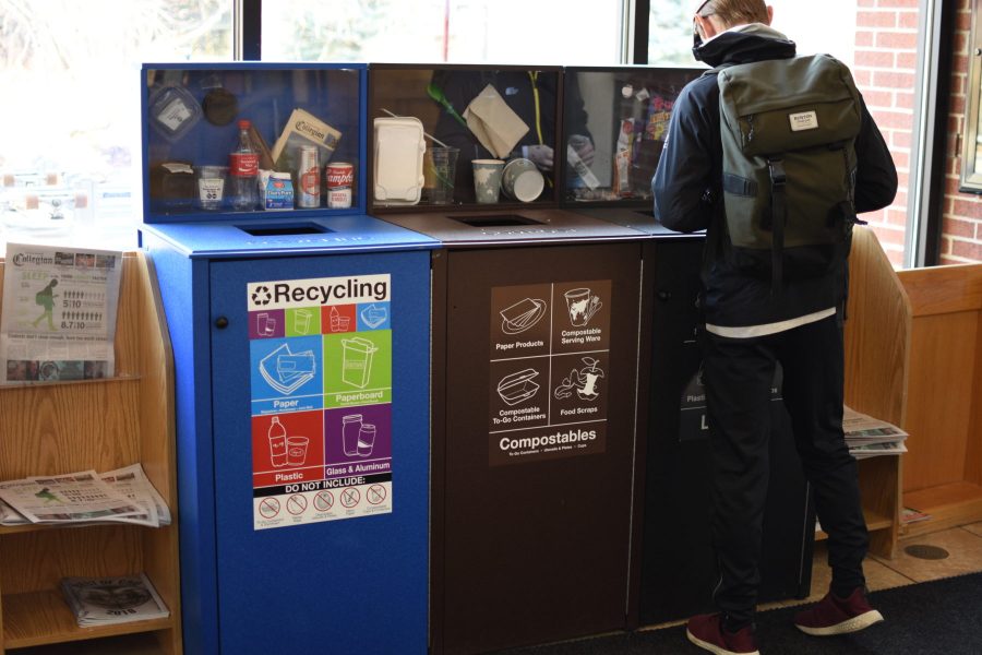 A student sorts his trash into a trash can and the compost bin that the Zero Waste team manages inside the Academic Village Commons. (Matt Tackett | Collegian)