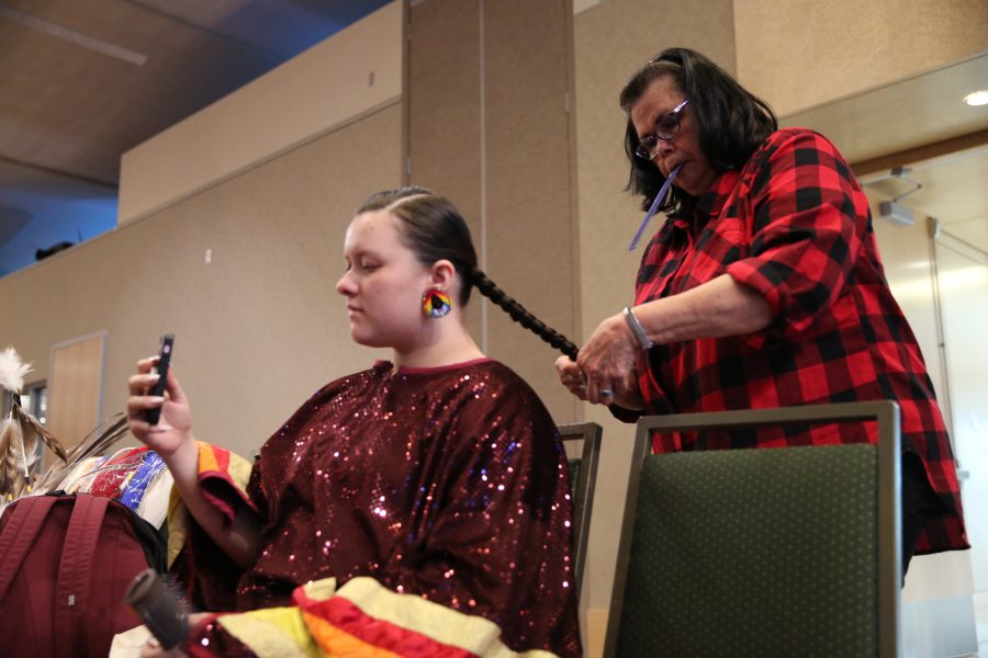 Diane Yankton braids her granddaughter, Morning Star Yazzie's, hair at the 36th annual AISES Pow Wow at the LSC on Nov. 3, 2018. (Forrest Czarnecki | Collegian)