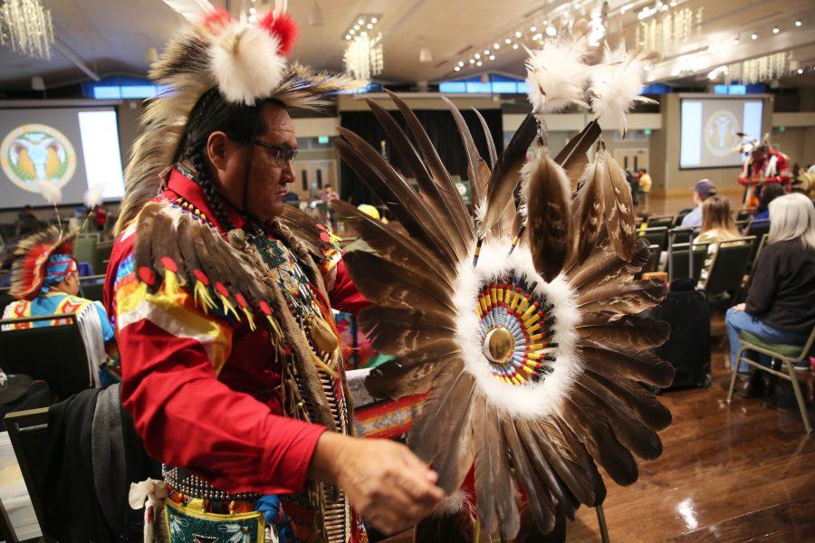 Dale Yazzie prepares his eagle bustle before the grand entry at the 36th annual AISES Pow Wow at the LSC on Nov. 3, 2018. (Forrest Czarnecki | Collegian)