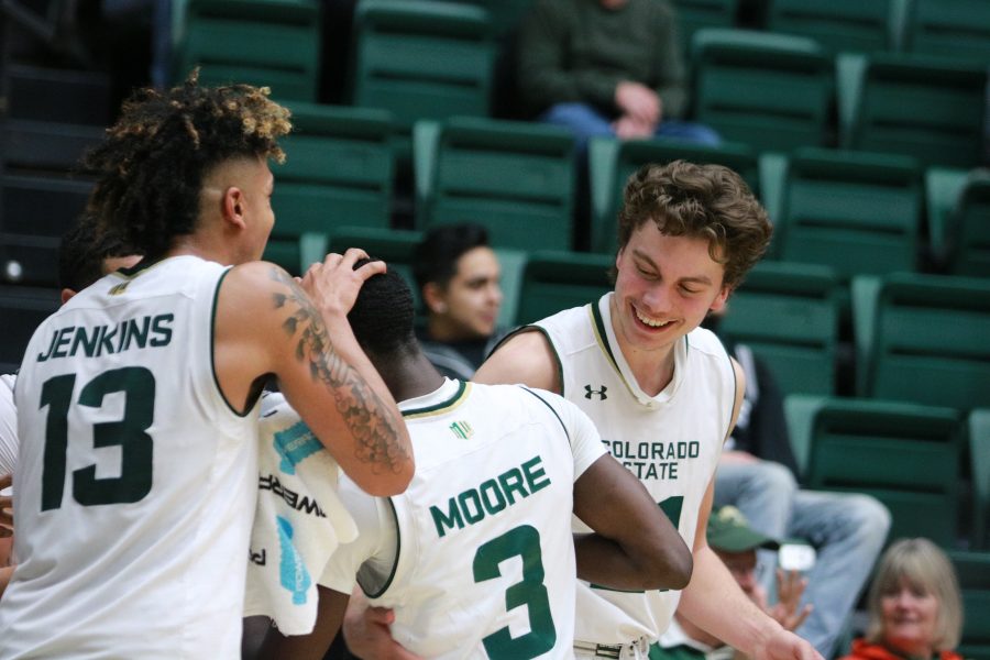 Lorenzo Jenkins (13) and Logan Ryan (21) congratulate Kendle Moore (3) as he goes to the sideline. The Rams beat the CCU Cougars 100-63 on Nov. 7.(Devin Cornelius | Collegian)