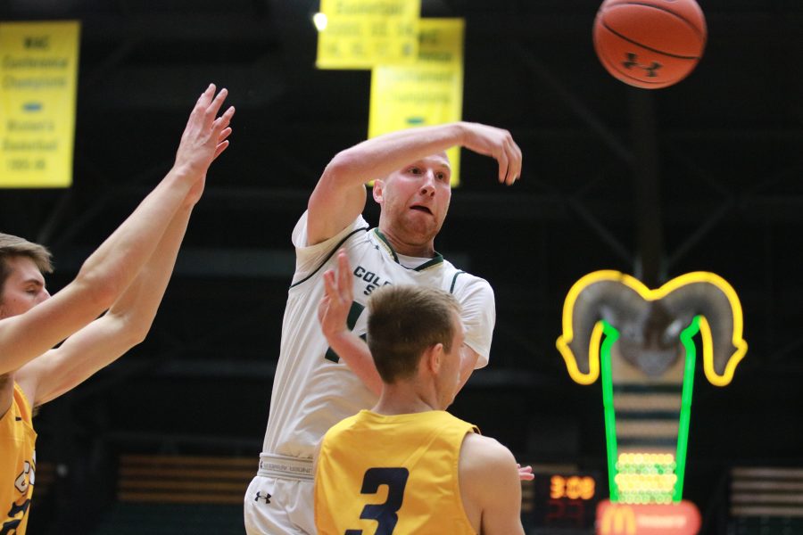 Robbie Berwick (13) passes the ball to a teammate as the Rams battle the Cougars. The Rams win 100-63 (Devin Cornelius | Collegian)
