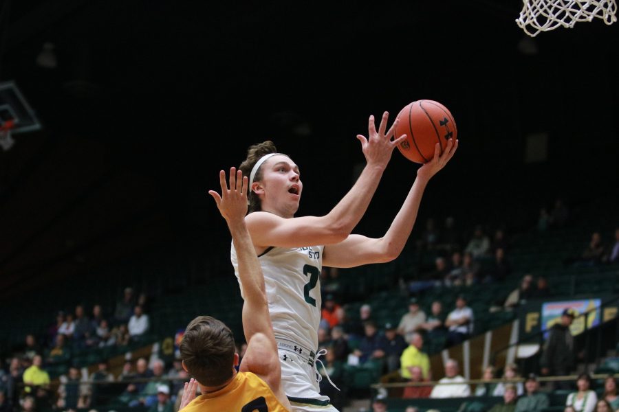 Logan Ryan (21) leaps to score for CSU as the Rams battle the Cougars. Rams win 100-63 (Devin Cornelius | Collegian)