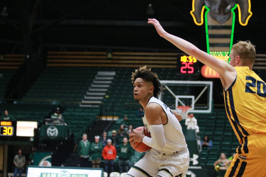 Lorenzo Jenkins (13) prepares to pass to a teammate as the Rams play at home vs the Cougars. Rams win 100-63 (Devin Cornelius | Collegian)