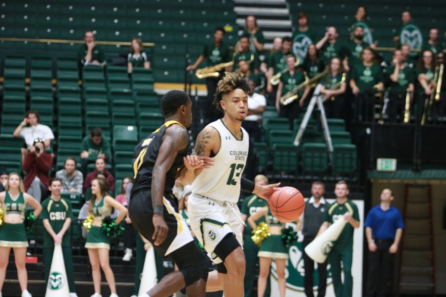 Lorenzo Jenkins (13) dribbles the ball down the court during CSU's game against UAPB. The Rams win 92-67. (Devin Cornelius | Collegian)